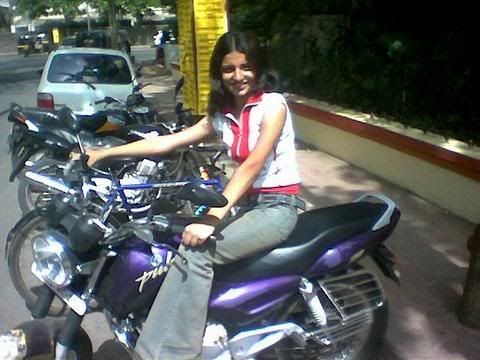 A Women driving on her husband bike 