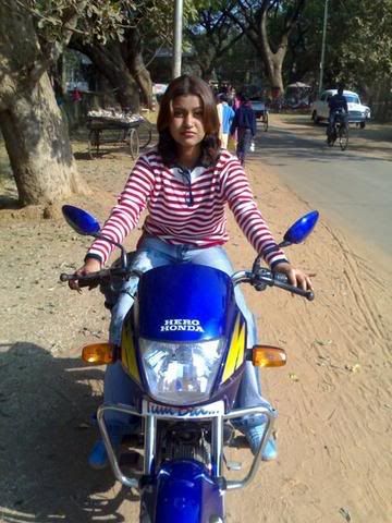 a girl driving her passion bike